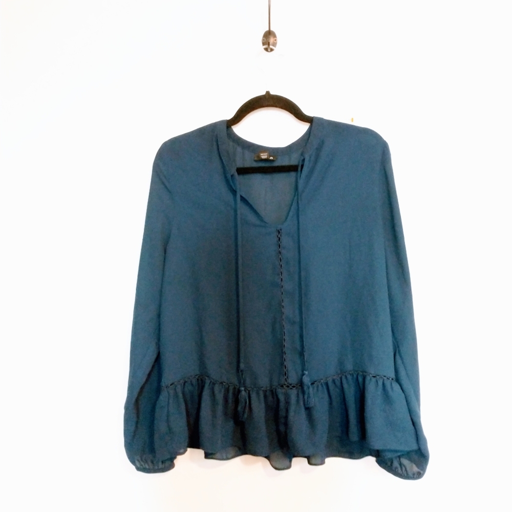 Ana blue long sleeve tunic with peplum detail near the hem and drawstrings at th